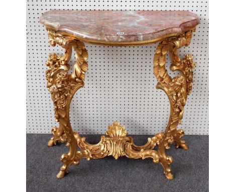 An 18th century style French console table, the shaped marble top on four floral moulded 'C' scroll supports, 19th century, 8