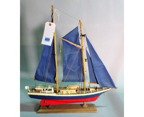 A modern wooden model of a sailing boat, 55cm wide x 61cm high. 
