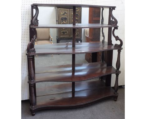 A 19th century Anglo-Portuguese mahogany mirror back display shelf, on five serpentine tiers, on spiral fluted baluster colum