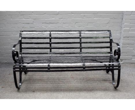 A 19th century black painted strap iron garden bench, 153cm wide x 78cm high. 