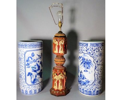 A pair of modern Asian style blue and white stick stands, 45cm high, and a carved and painted lampbase, 76cm high.