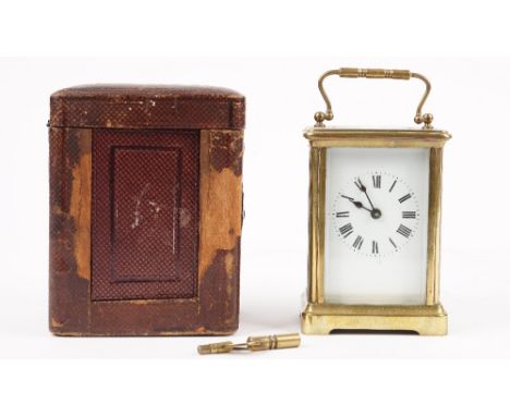 An early 20th century brass cased carriage clock with enamel dial, visible escapement and single train movement, 11.5cm high,