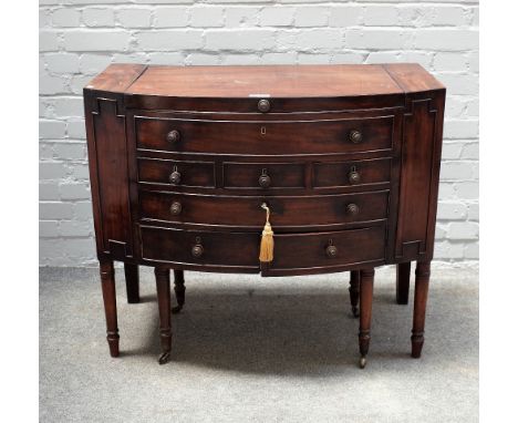 A Regency mahogany bowfront wash stand, with fitted interior on turned supports, 95cm wide x 81cm high.