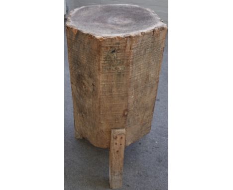 A large primitive made trunk-form chopping block, on three square supports, 50cm diameter x 89cm high.