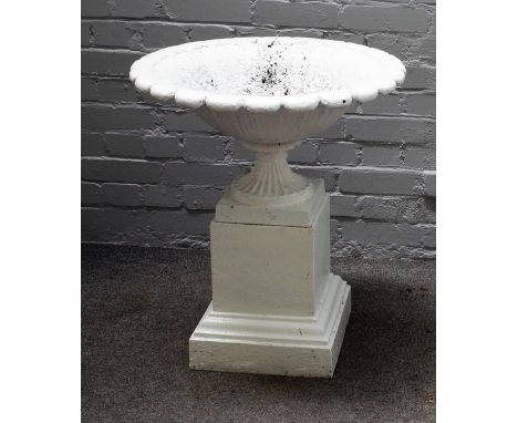 A white painted cast iron urn, on stepped square stand, 60cm diameter x 78cm high. 