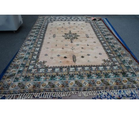 A Moroccan carpet, African, the pink field with a central medallion, minor motifs, a variety of borders, 392cm x 288cm. 