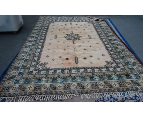 A Moroccan carpet, African, the pink field with a central medallion, minor motifs, a variety of borders, 392cm x 288cm. 