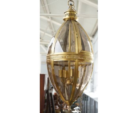 A modern gilt metal lantern of ovoid form, with glazed panels, pierced central circlet and internal four light fitment, 90cm 