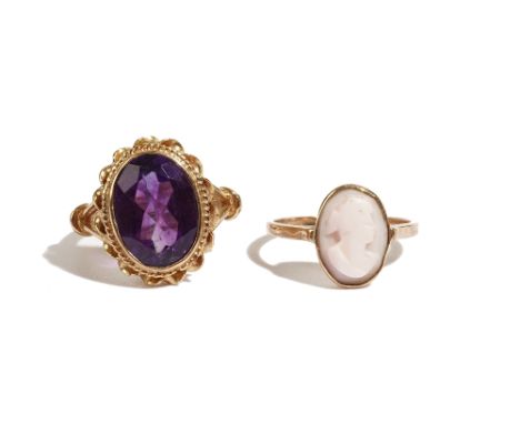 A 9ct gold ring, collet set with an oval cut amethyst within a ribbon twist surround, London 1973, ring size N and a gold and