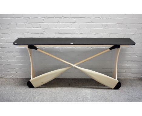 A 20th century console, the ebonised top over a base of two crossed rowing oars, 173cm wide x 77cm high. 