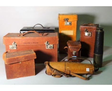 A collection of leather cased items including a brass telescope, a Rolleiflex camera, cased Ordinance Survey maps, a compass,