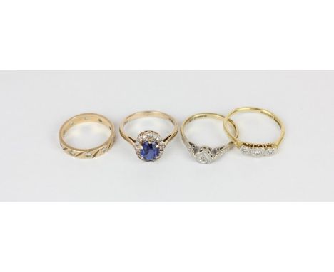A sapphire ring; two illusion set diamond rings and a full hoop ring
