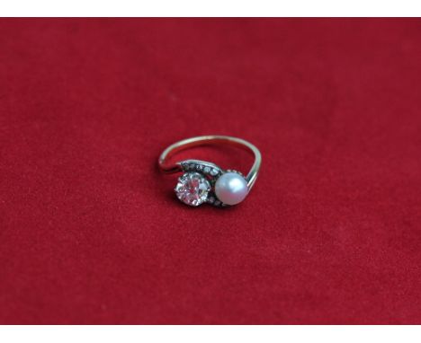 An old cut diamond and pearl crossover ring