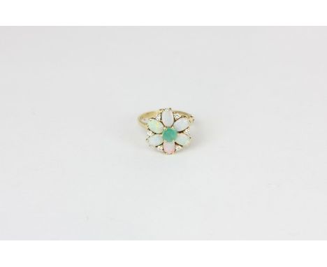 An opal and emerald cluster ring in 9ct yellow gold