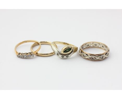 A 14ct gold emerald and diamond ring, a diamond five-stone ring, a 9ct gold wedding ring, and a white sapphire ring in 9ct go