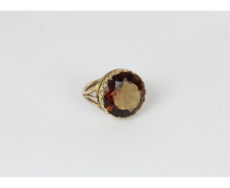 A citrine dress ring the round stone multi claw set above a pierced gallery in yellow gold