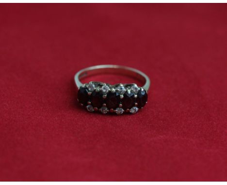 A garnet five stone ring in 9ct gold