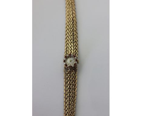 A lady's 9ct gold and gem set Beuche Girod bracelet watch, manual wind, the bezel set with rubies and diamonds