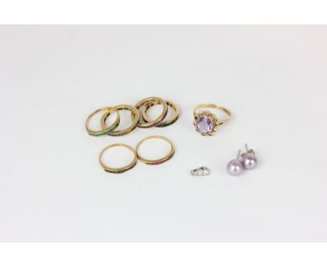 An amethyst ring in 9ct gold, six various full and half hoop eternity rings variously gem set (some stones missing) and a pai