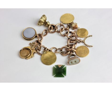 A gold charm bracelet hung with various pendants including a spade guinea and hardstone seals 79.9g gross - mixed carats; and