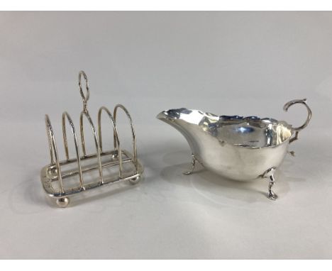 A Victorian silver four division toast rack, maker Henry Wilkinson &amp; Co, London 1895, together with a silver sauce boat, 