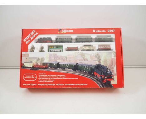 A FLEISCHMANN N gauge 9397 analogue passenger and freight starter set with steam loco, appears complete with little or no use