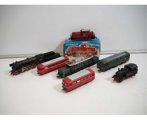 A group of mostly MARKLIN HO gauge unboxed rolling stock to include a BR194 electric locomotive, railbus and trailer car toge