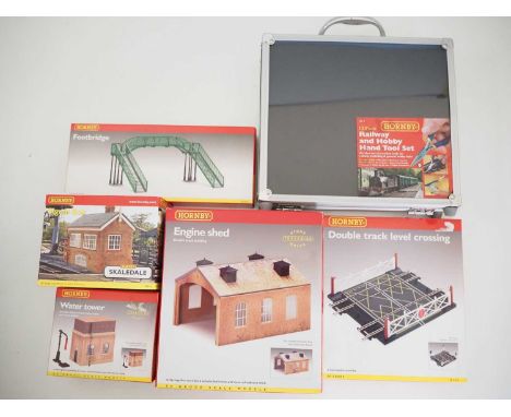 A mixed group of OO gauge HORNBY plastic kits comprising Footbridge, Water tower, Engine shed and Double track level crossing