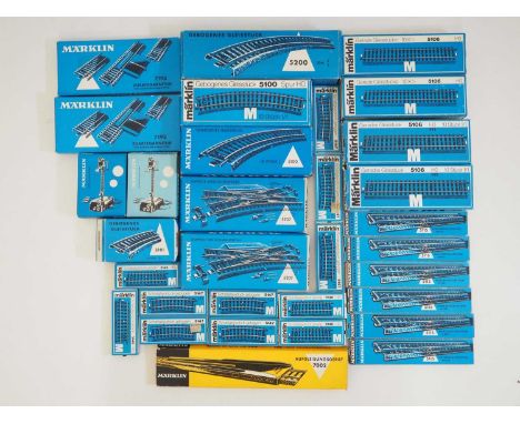 A mixed group of boxed MARKLIN HO gauge M track and accessories to include a 7002 metal re-railer together with track curves,