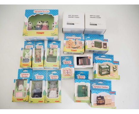 A group of TOMY SYLVANIAN FAMILIES comprising family members and accessories including an accordion, a grand piano and a gram