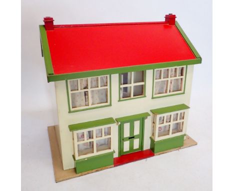 A vintage 1950's dolls house with lighting and contents 