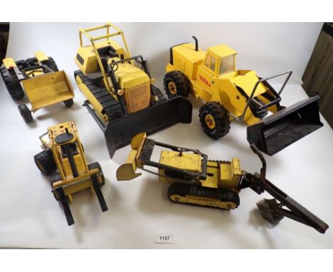 A group of vintage Tonka toys including diggers, scraper etc.