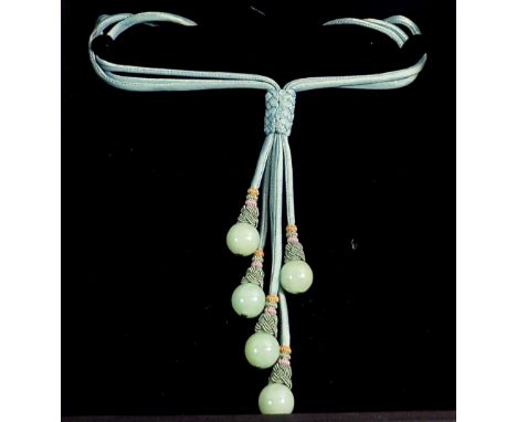 A green silk multi strand necklace with five jade beads, boxed