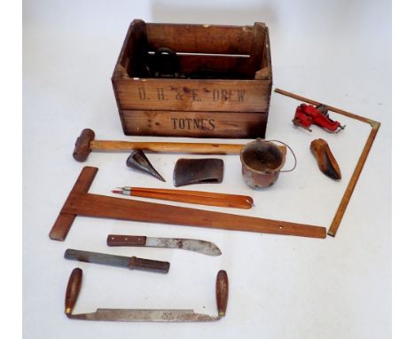 An unusual tear drop form log splitter, garden hoe head and other tools in wooden crate