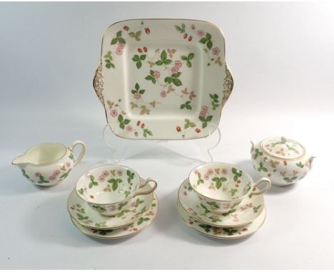 A Wedgwood Wild Strawberry tea service comprising:- sixteen tea cups and saucers, sixteen tea plates, cake plate, sugar and t