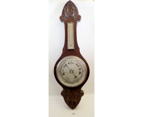 A Victorian carved oak barometer/thermometer,  80cm long
