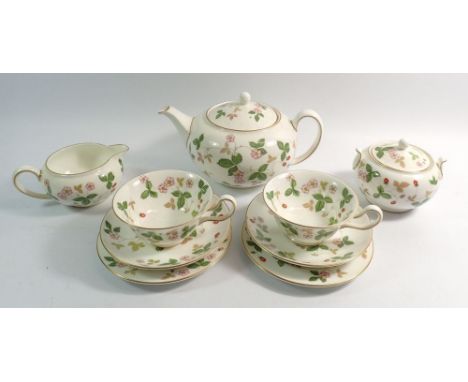 A Wedgwood Wild Strawberry tea service comprising:-teapot, sixteen cups and saucers, two milk jugs, sugar, cake plate and six