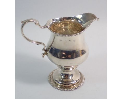A George III silver cream jug on pedestal foot, London 1766 by WS, 11cm, 136g