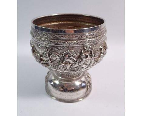 A Burmese silver Thabeik rice bowl chased with dancing and fighting figures in high relief, inscription to Sergeant Major C D