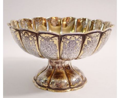 A Victorian silver gilt bowl with embossed Persian style decoration, raised on pedestal foot, by George Fox, London 1868, 16c