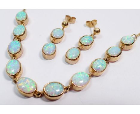 A 9 carat gold necklace set ten oval black opals, 53cm long plus a pair of matching pendant opal earrings, 2cm drop, 15g tota