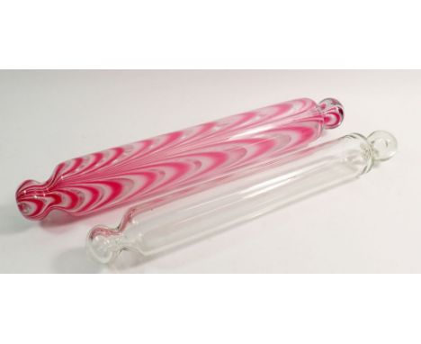 A Nailsea pink and white opaque glass rolling pin and another clear glass rolling pin, largest 41cm long