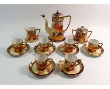 A Noritake coffee service painted desert scenes comprising coffee pot, milk, sugar and six coffee cans and saucers