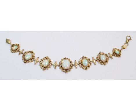 A 9 carat gold opal bracelet, the seven graduated fancy scrollwork links each set an opal, 19.5cm, 26g