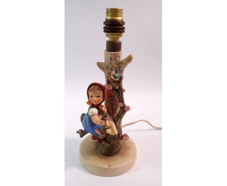 A Hummel table lamp with girl seated in tree, 24cm high