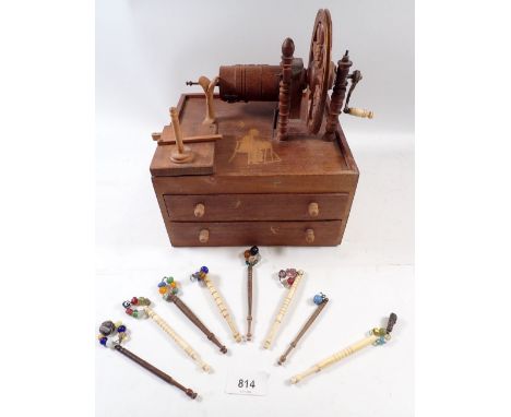 An antique treen lace bobbin winder on drawer base, 22cm wide and contents of eight wood and bone turned bobbins