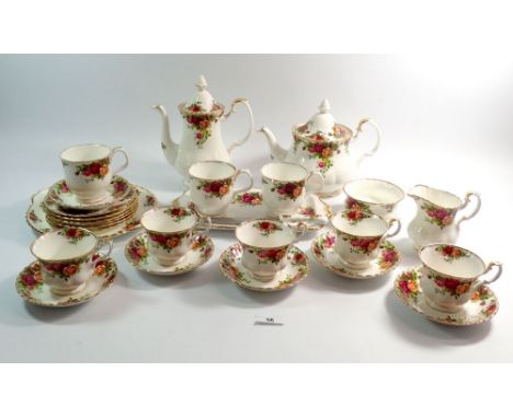 A Royal Albert Country Roses part tea and coffee service comprising:- teapot, coffee pot, five tea cups and six saucers, suga