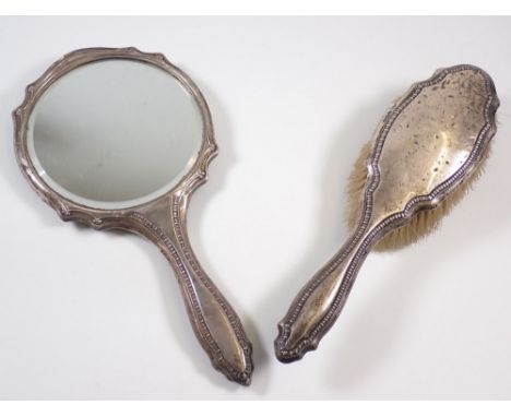 A silver backed brush and mirror 