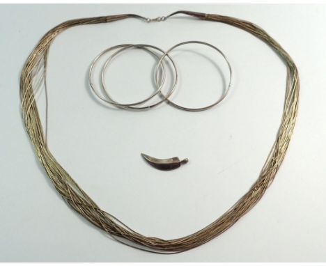 A group of silver jewellery including multi strand necklace, tooth form pendant and triple bangle