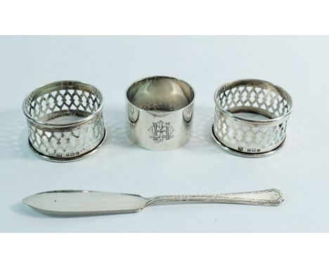 A pair of silver napkin rings, Birmingham 1931 by W J Myatt &amp; Co. and one other and a butter knife, 82.5g total weight